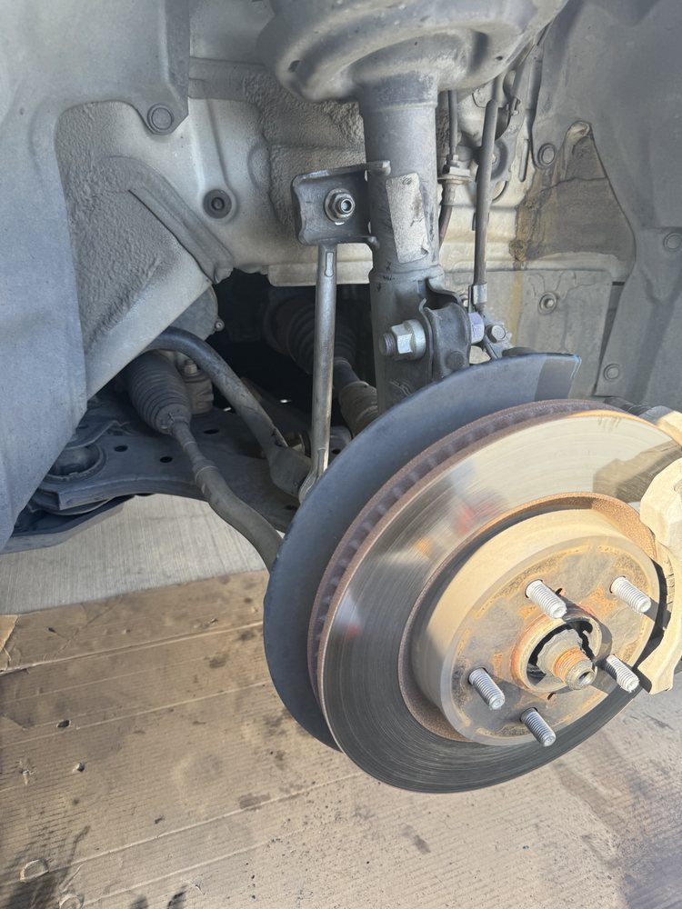 Front brake rotor and hub inspection with the wheel removed -- mobile brake service.