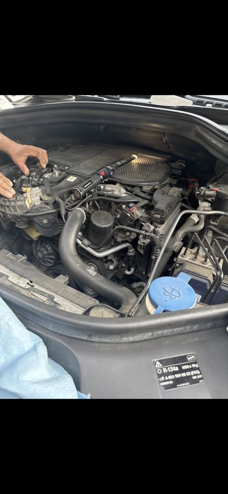 Spark plug replacement on a Mercedes-Benz V6 with intake manifold removal for proper access.