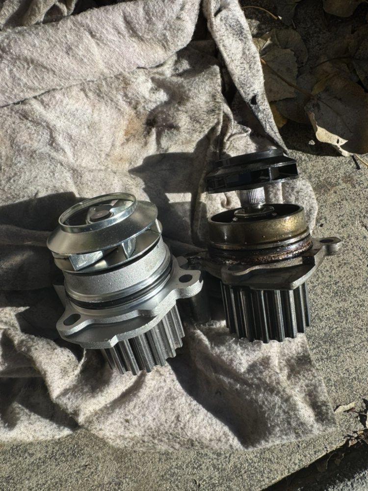 Visible water pump failure: the plastic impeller has separated from the shaft, causing loss of coolant circulation and engine overheating.
