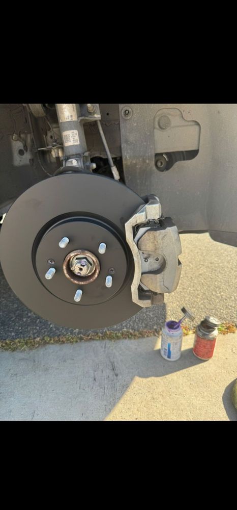 New brake rotor and pads installed -- clean, safe braking restored.