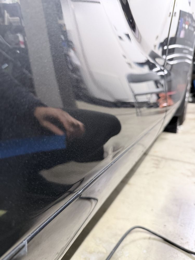 Mirror-finish paint after polishing -- deep gloss restored on the door panel.